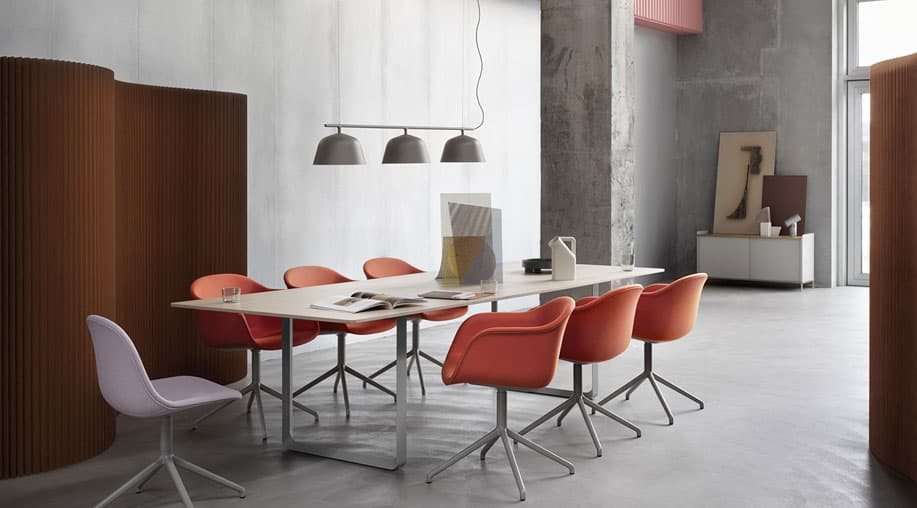 Modern conference room with coral chairs and pendant lighting